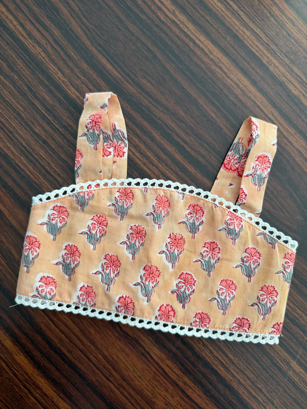 Floral-patterned headband on a wooden surface