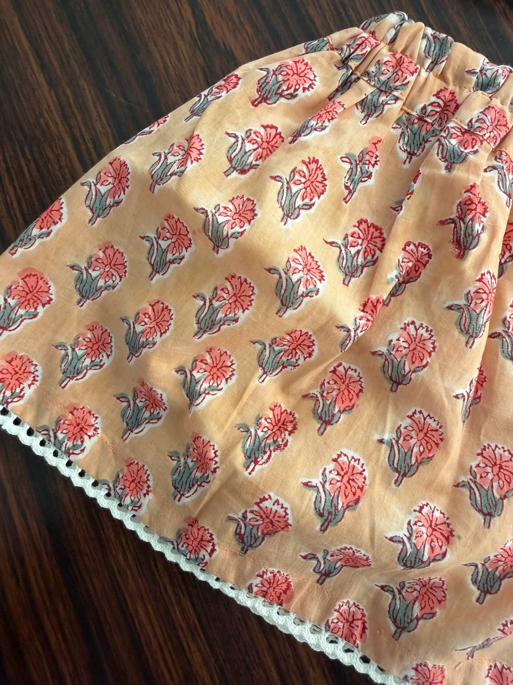 Floral-patterned fabric on a wooden surface