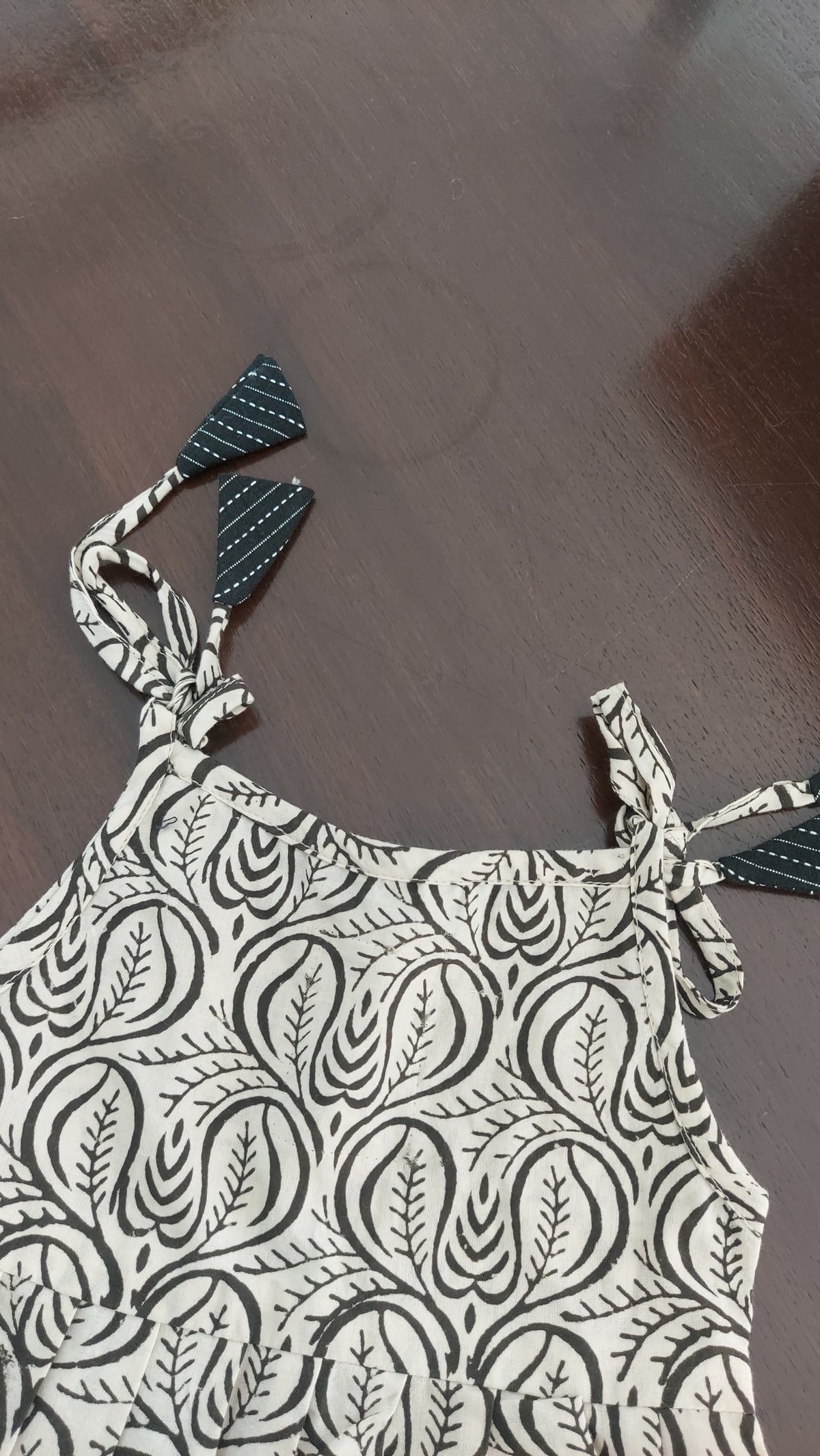 Black and white patterned top on a wooden surface