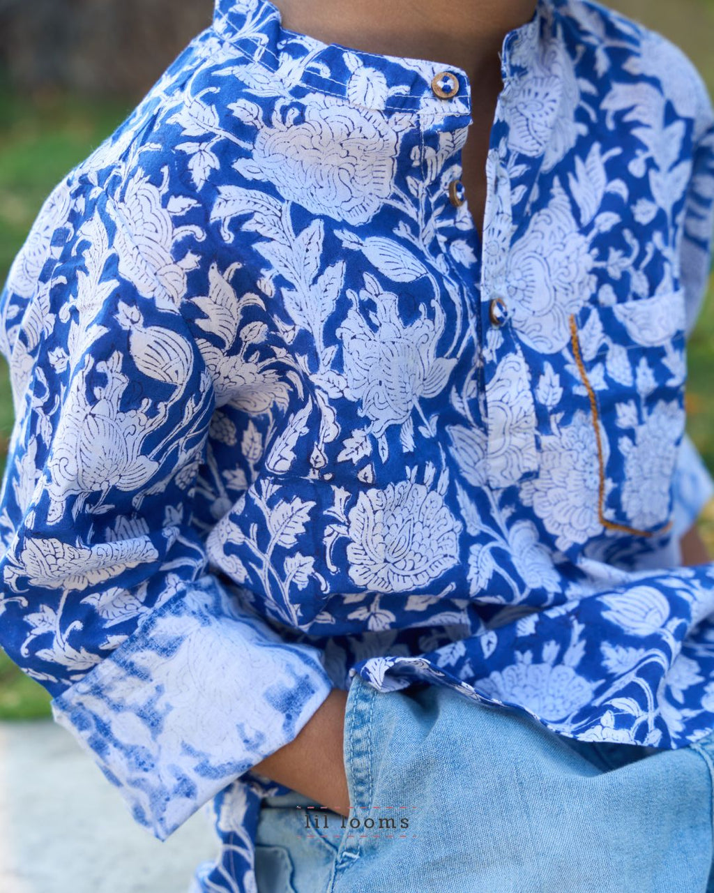 Person wearing a blue and white floral Handblock print kurta with rolled-up sleeves.