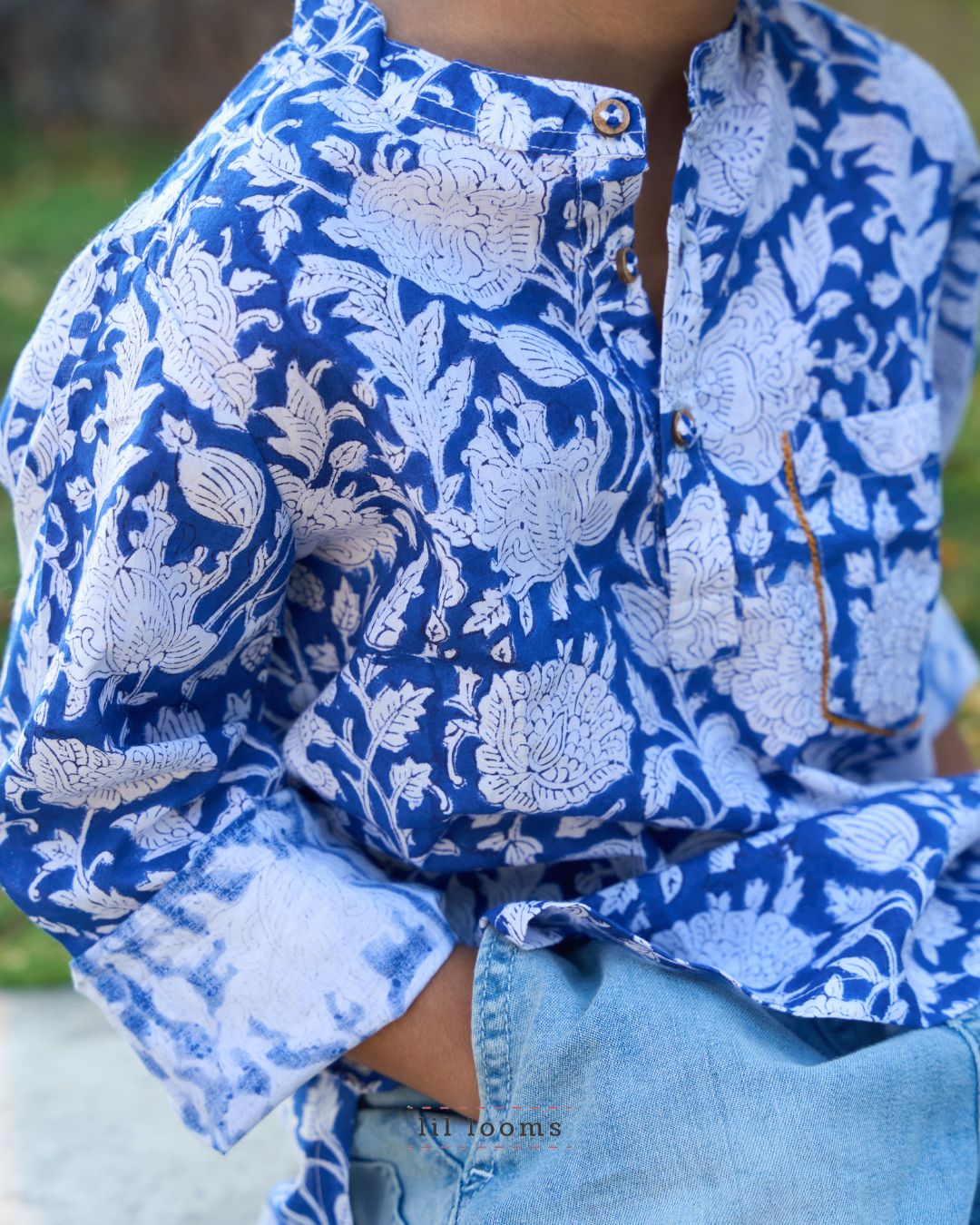 Person wearing a blue and white floral Handblock print kurta with rolled-up sleeves.