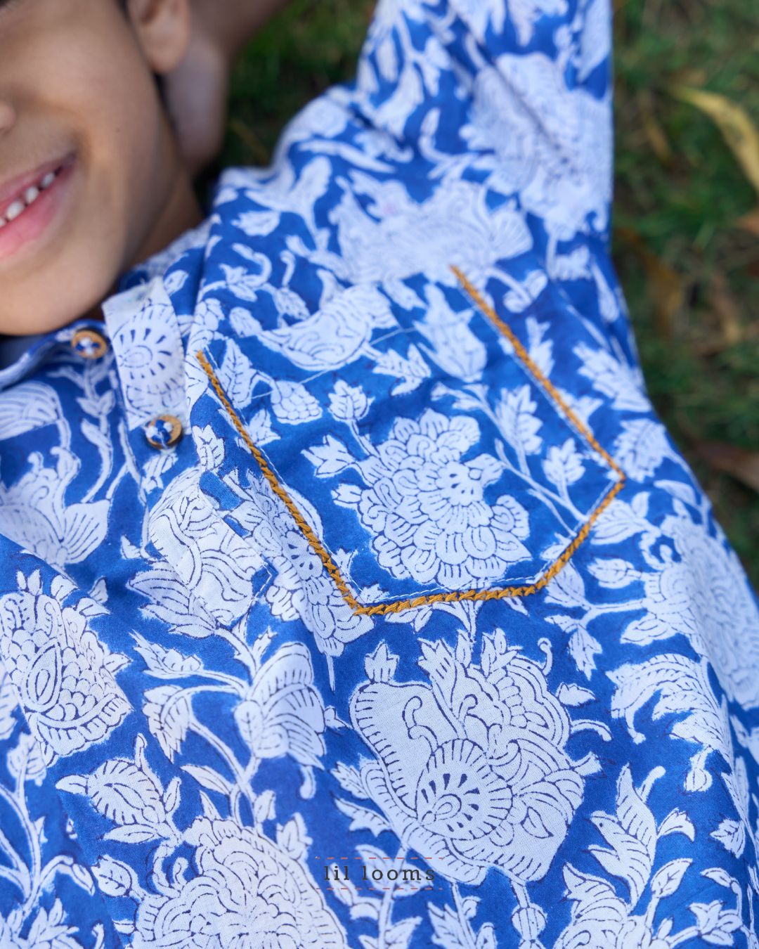 Close-up of a blue Handblock print cotton kurta with a gold necklace.