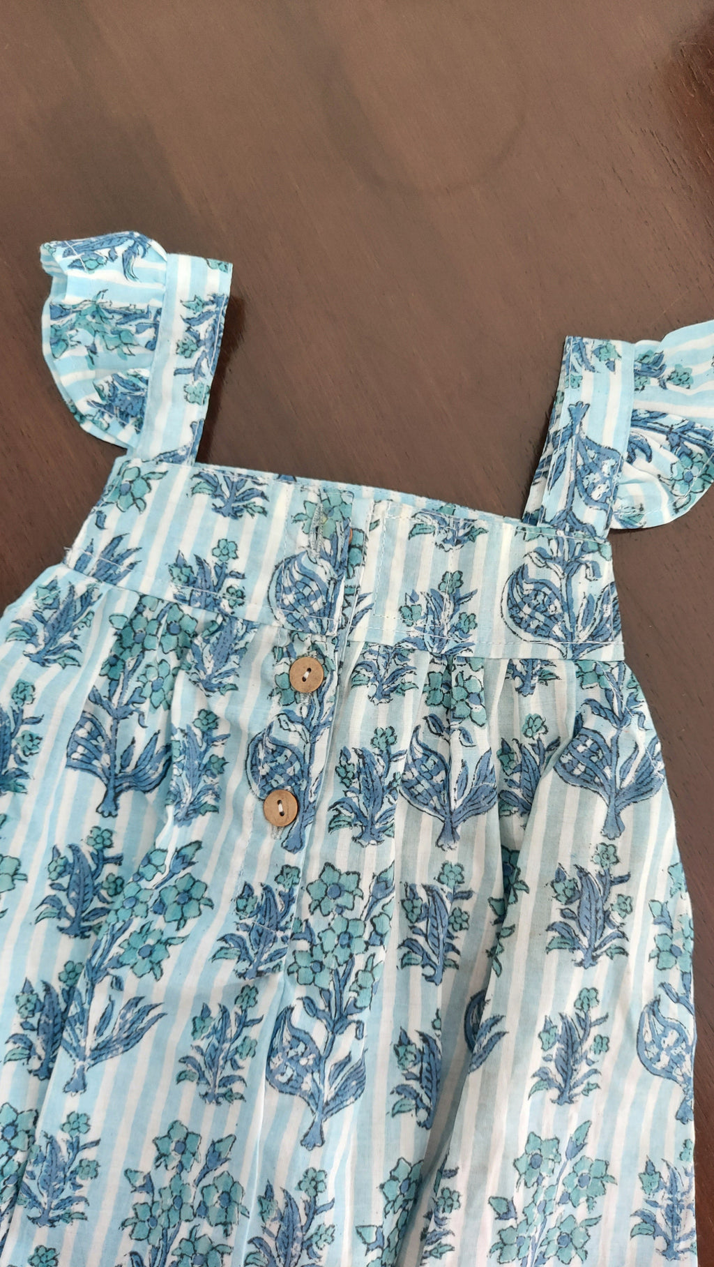 Floral patterned shirt on a wooden surface
