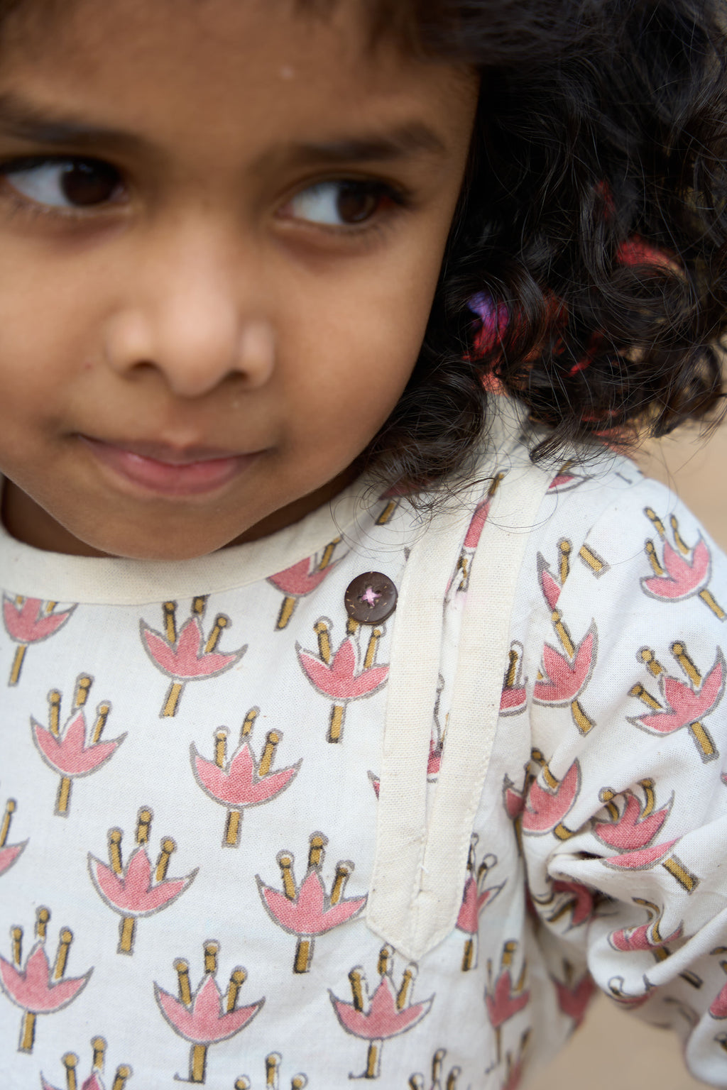 Close-up of a child wearing a dress with a floral pattern