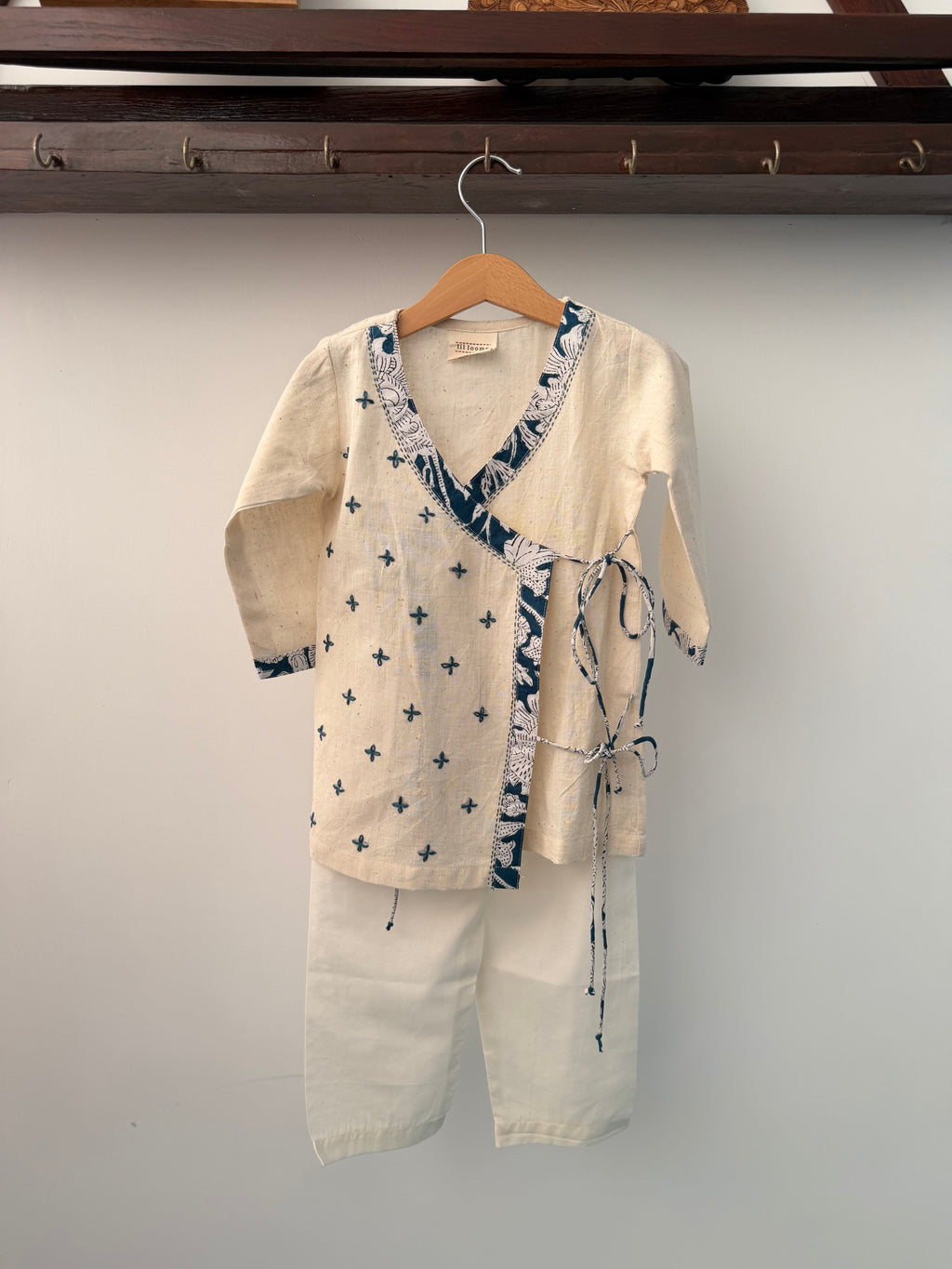 Beige shirt with blue floral pattern on a gray background