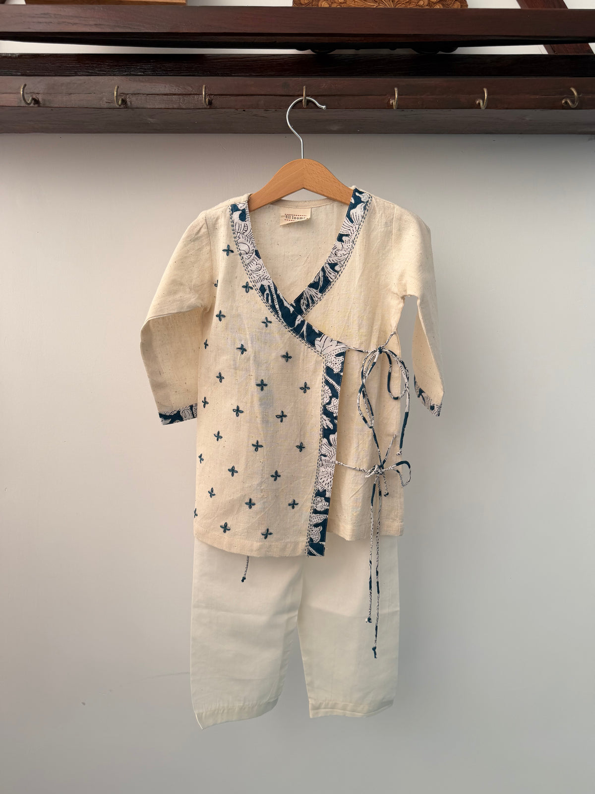 Beige shirt with blue floral pattern on a gray background