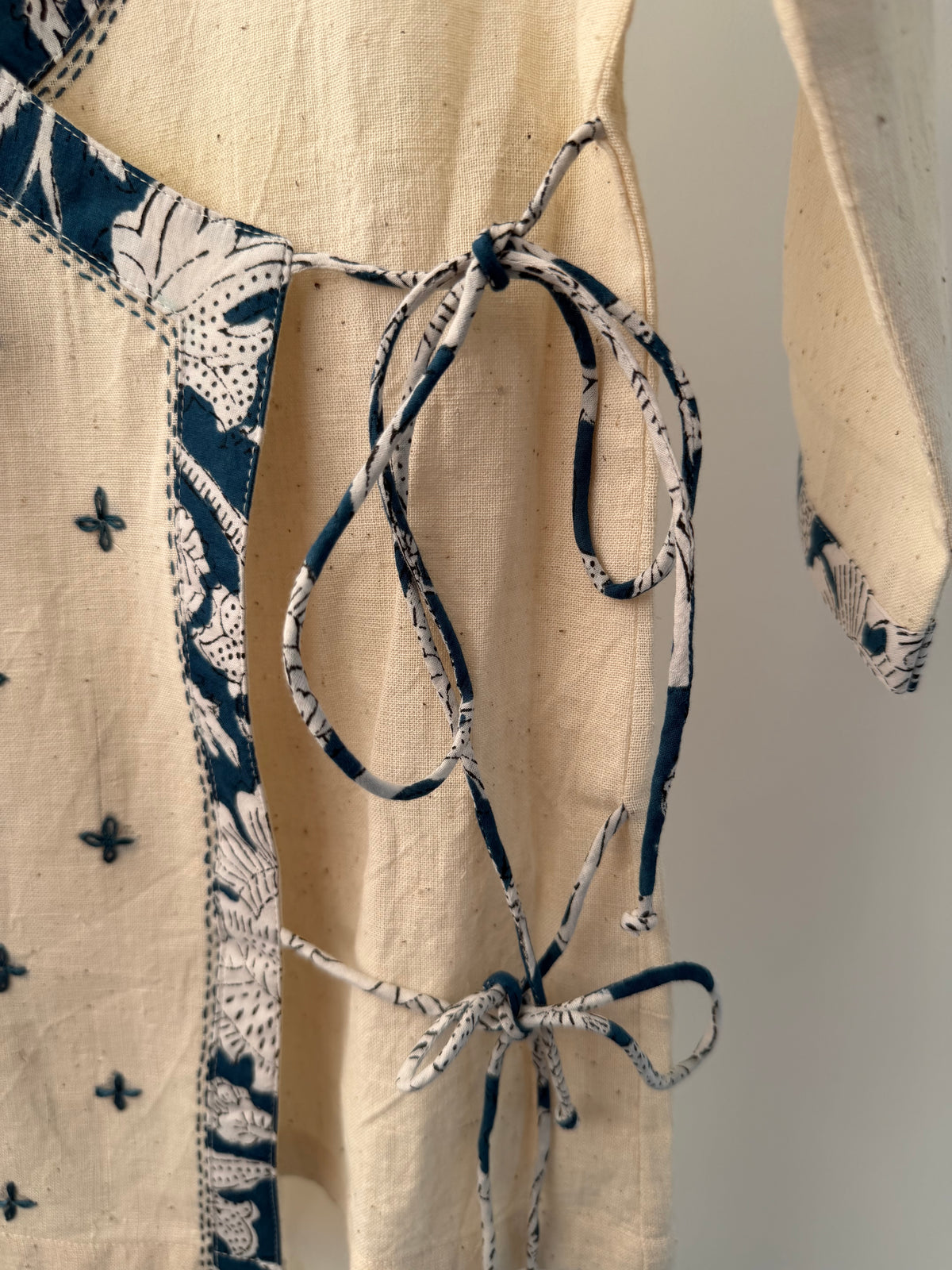Beige fabric with black floral patterns on a neutral background
