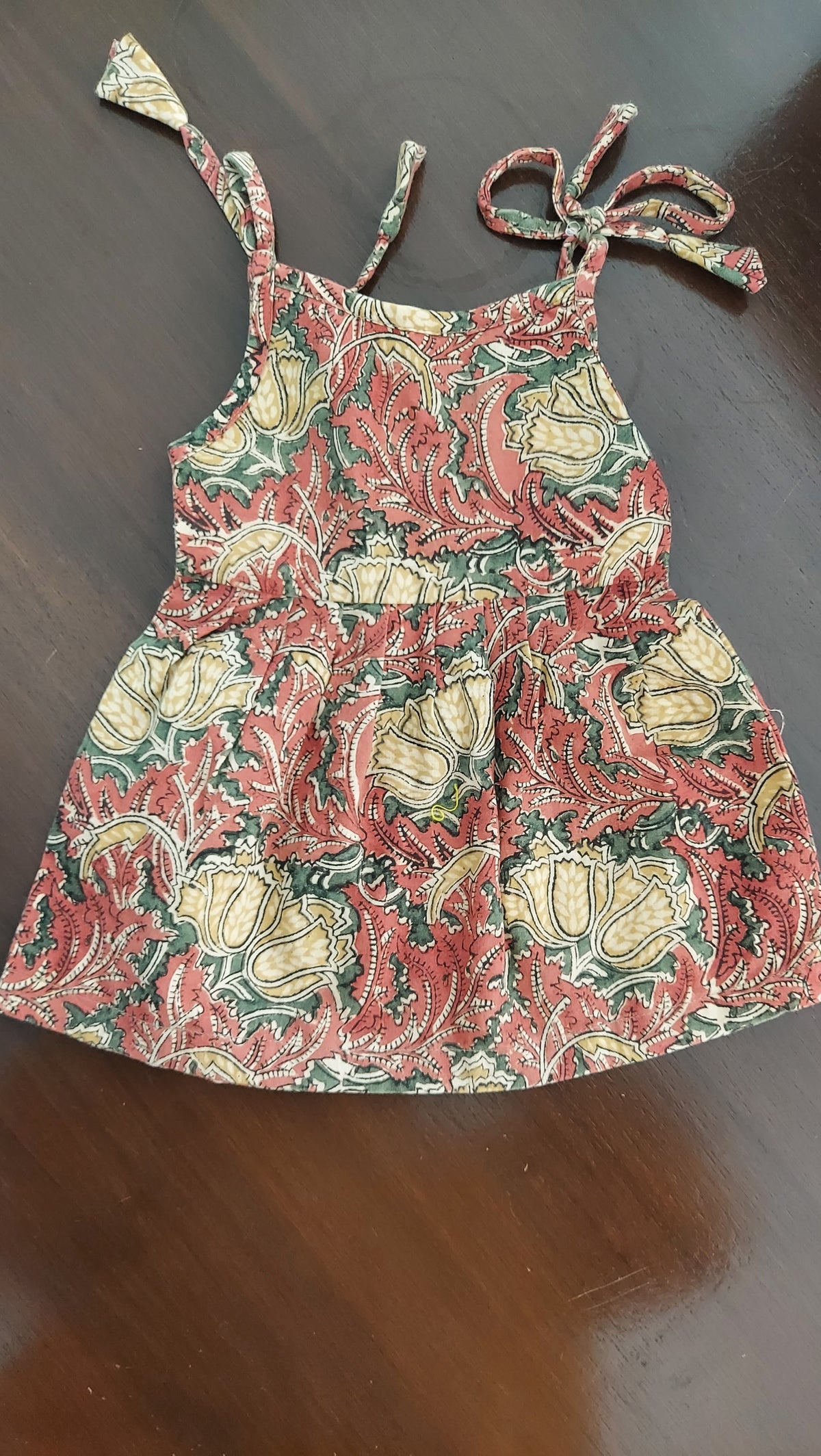 Floral patterned dress on a dark surface