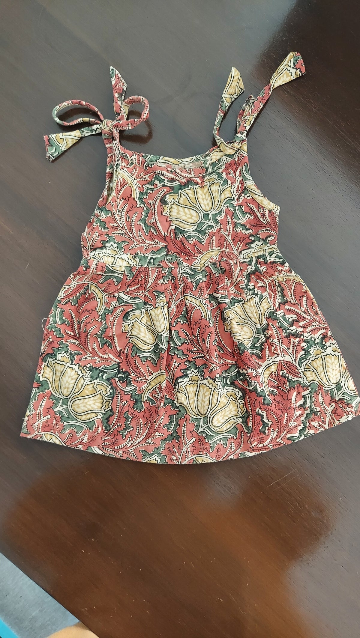 Floral-patterned dress on a dark surface