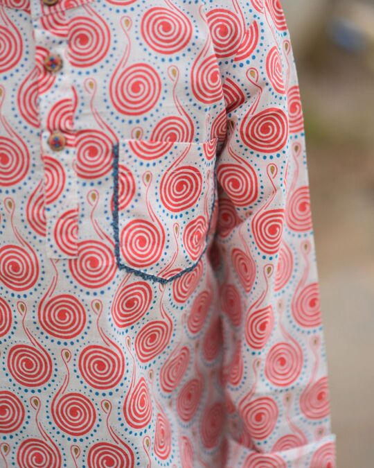 Close-up of a fabric with red spiral pattern on a blurred background